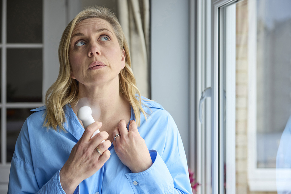 woman having a hot flash as part of her menopause symptoms